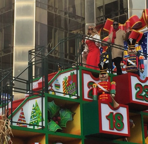 Singer Mariah Carey smiles at parade goers.